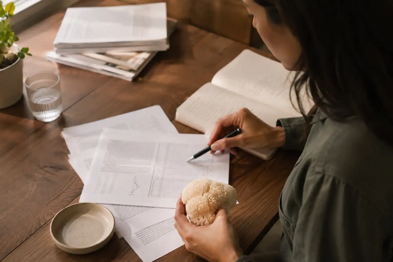 Researcher reviewing Lion’s Mane study results beside a fresh mushroom