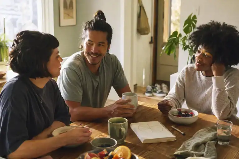 Three friends planning a realistic wellness week over breakfast